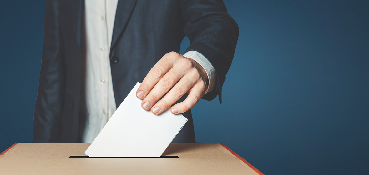 man placing ballot in box