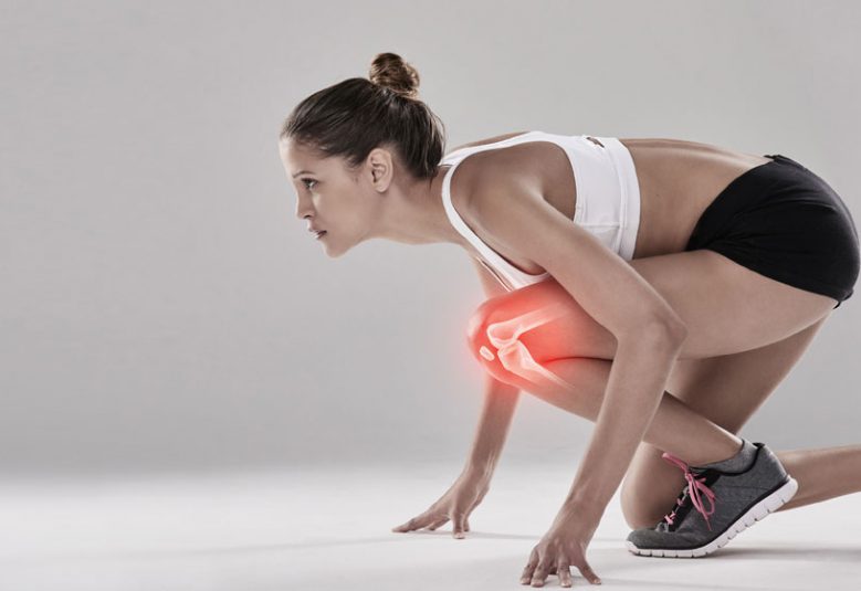 Woman crouching with sore knees