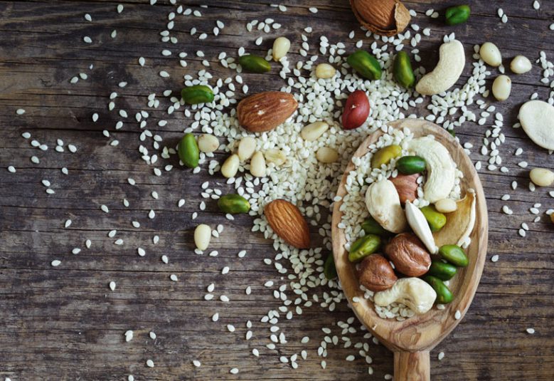 Wooden spoon with seeds and nuts