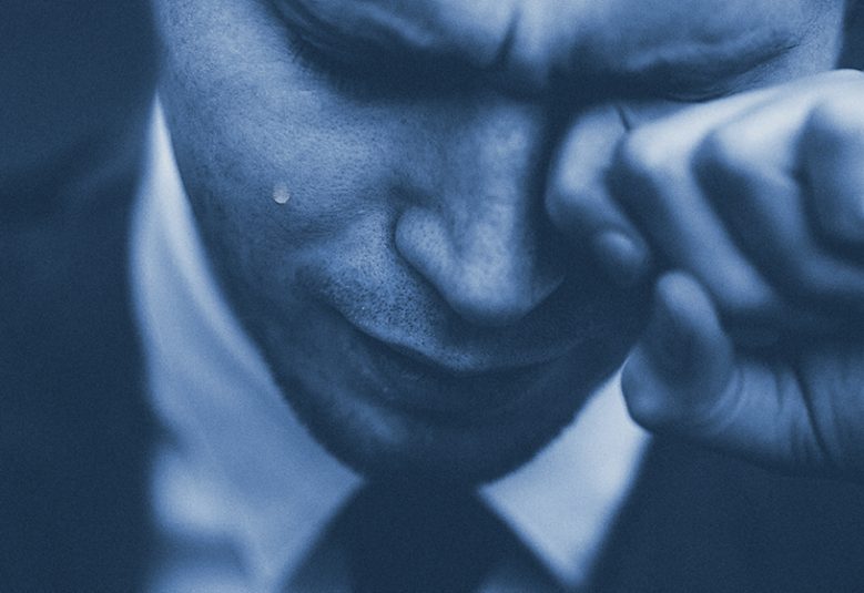 close up of professional man crying