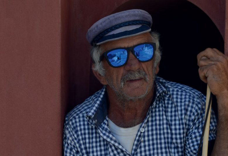 Elderly European man standing in a doorway