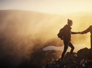 Two young people hiking at sunrise