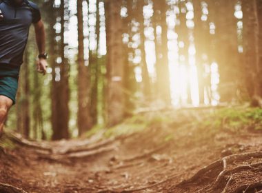 Man running through a wooded area