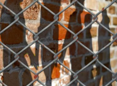 Chain-link fence outside a prison exercise yard