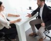 Man and woman discussing documents at a desk