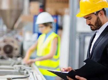 manager supervises factory assembly line