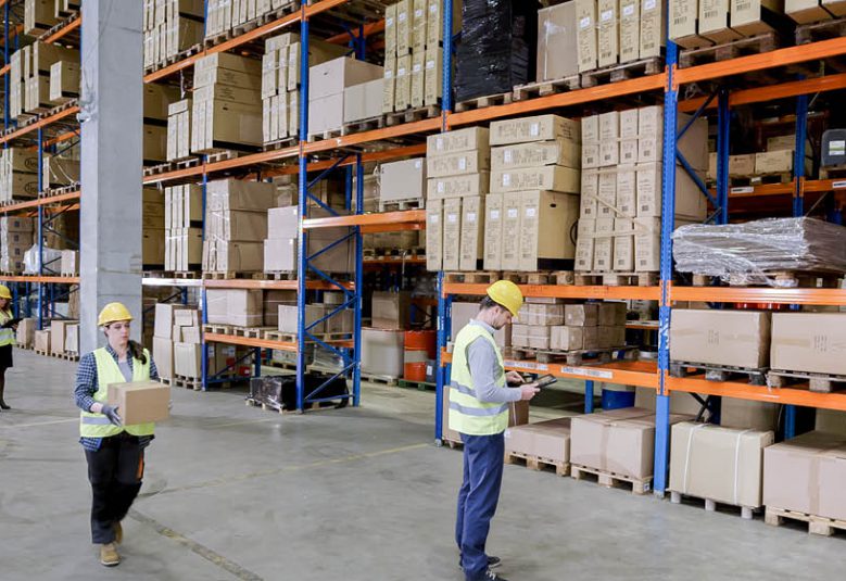 staff move boxes in a warehouse