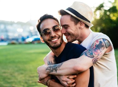 Two men hugging in a park