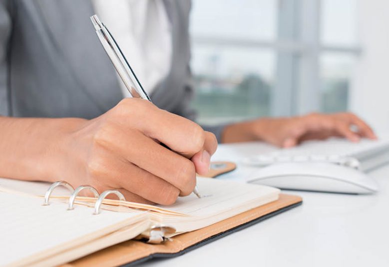 Female solicitor writing in a notebook