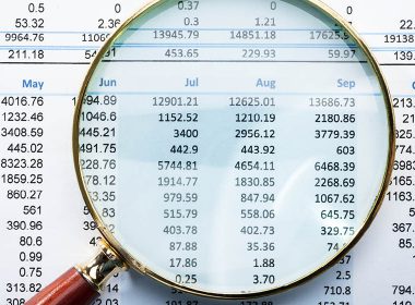 Magnifying glass highlighting figures on a financial statement