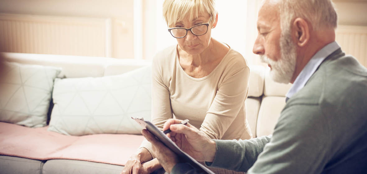 Solicitor reviews document with older female client