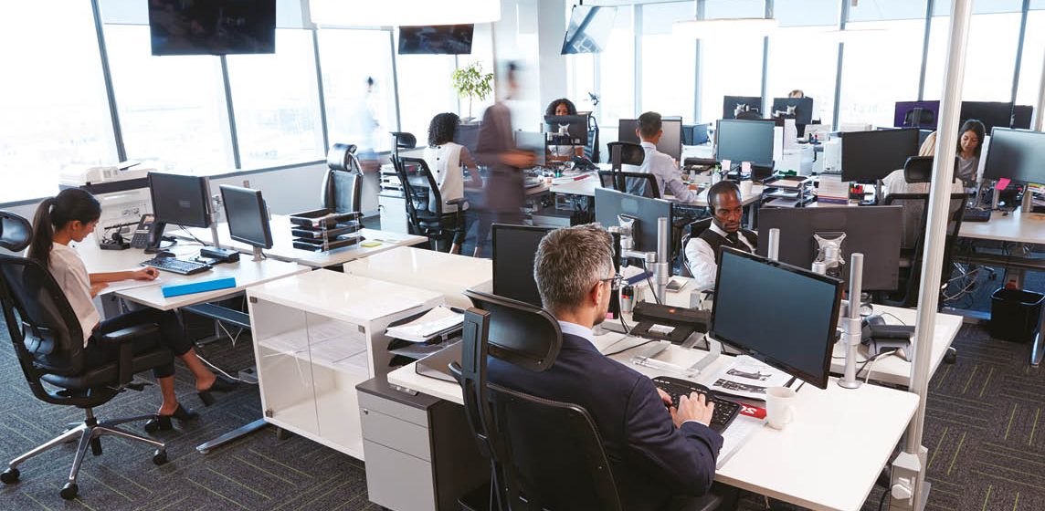 open plan office with staff working at computer