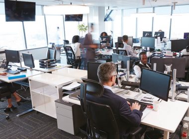 open plan office with staff working at computer