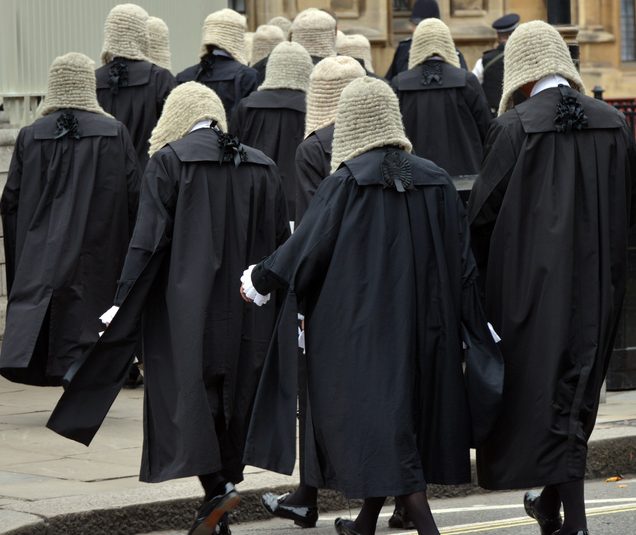 British judges wearing traditional ceremonial wigs and robes in a procession at Westminster, London