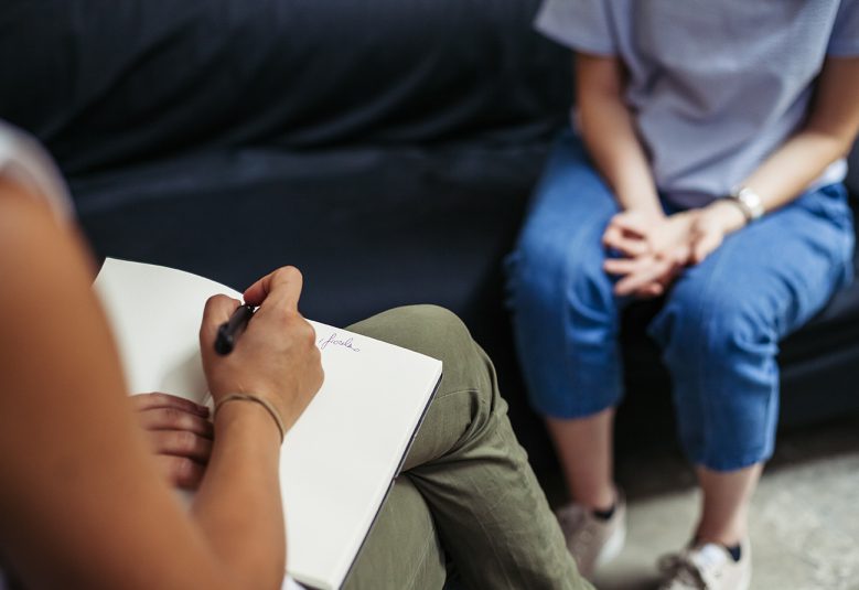 Psychotherapy session, woman talking to his psychologist in the studio