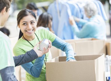 Volunteers pack cartons.