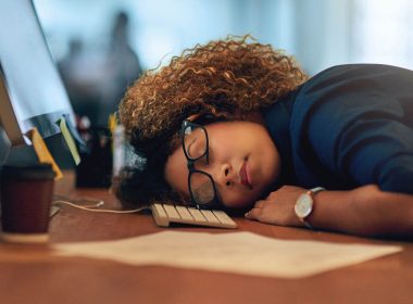 woman sleeping at desk