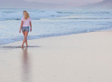 woman walking along the beach