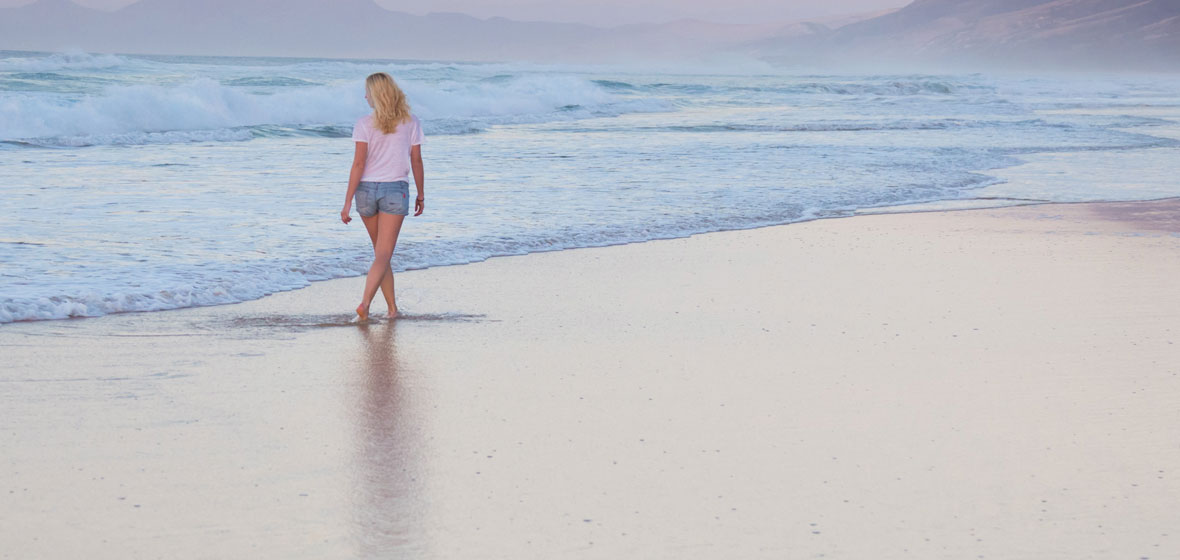 woman walking along the beach