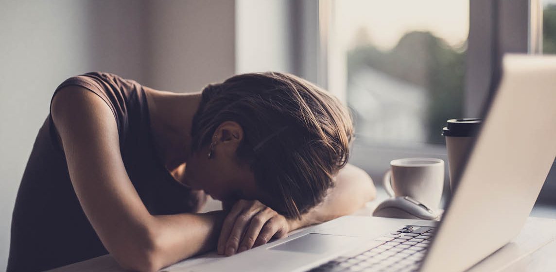 woman with head on desk