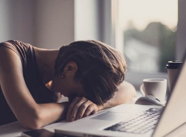 woman with head on desk