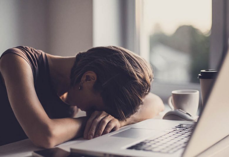 woman with head on desk