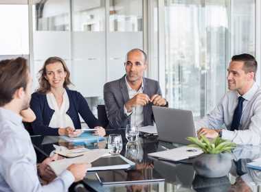 Colleagues sitting at a boardroom table