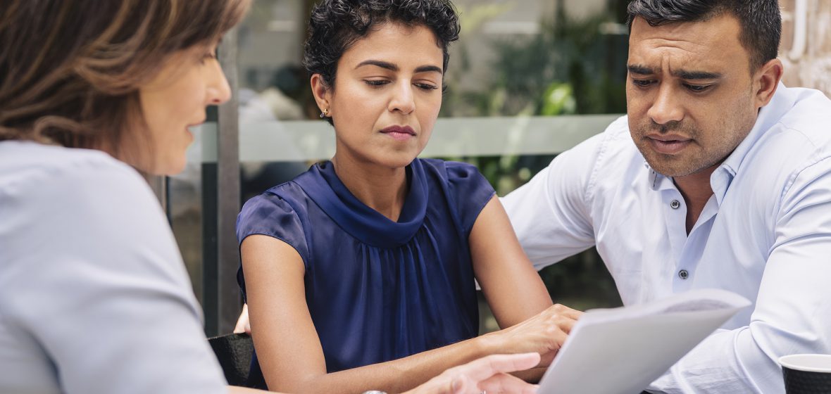 Professional discussing document with couple