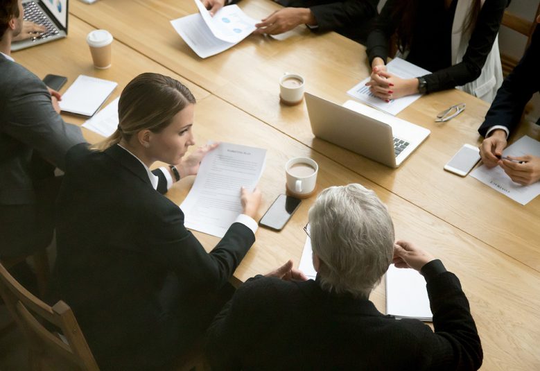 team of solicitors sitting at a table reviewing documents