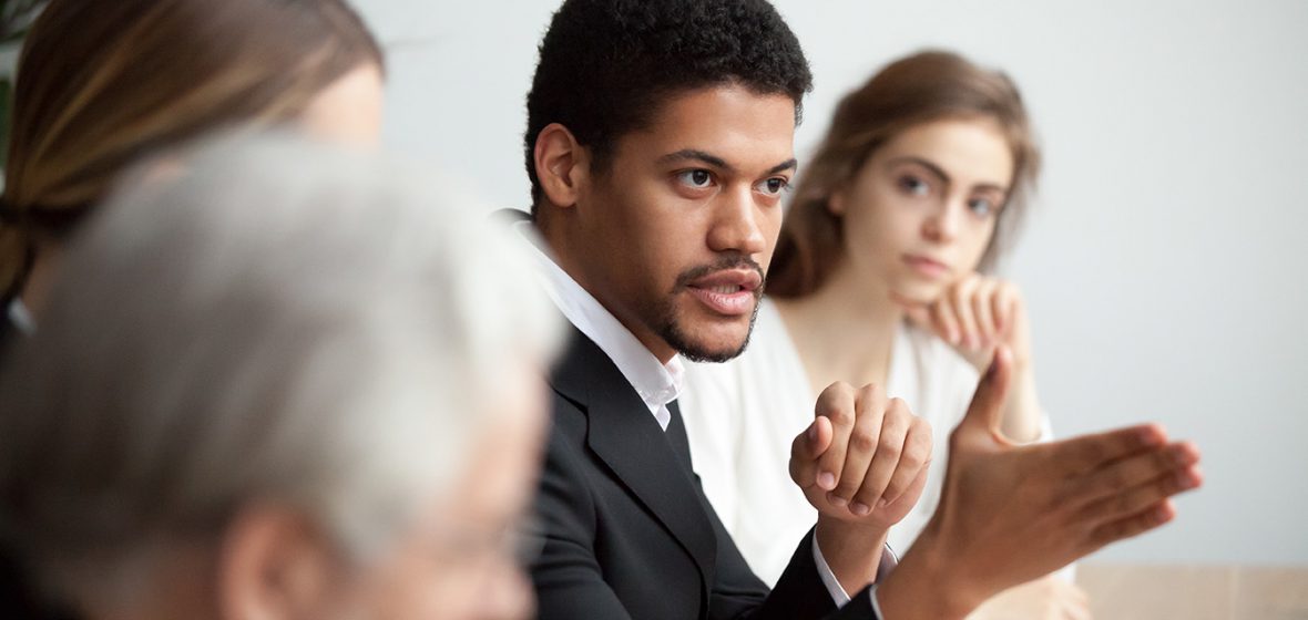 Chairperson speaking at a board meeting