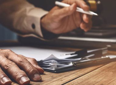 man signing document