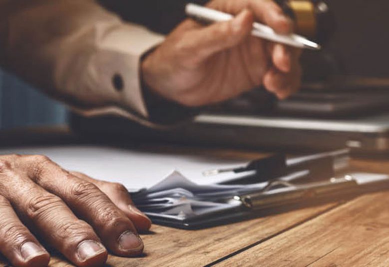 man signing document