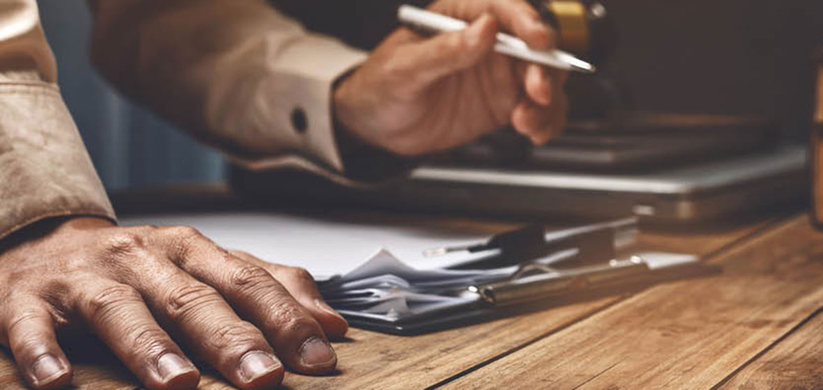 man signing document