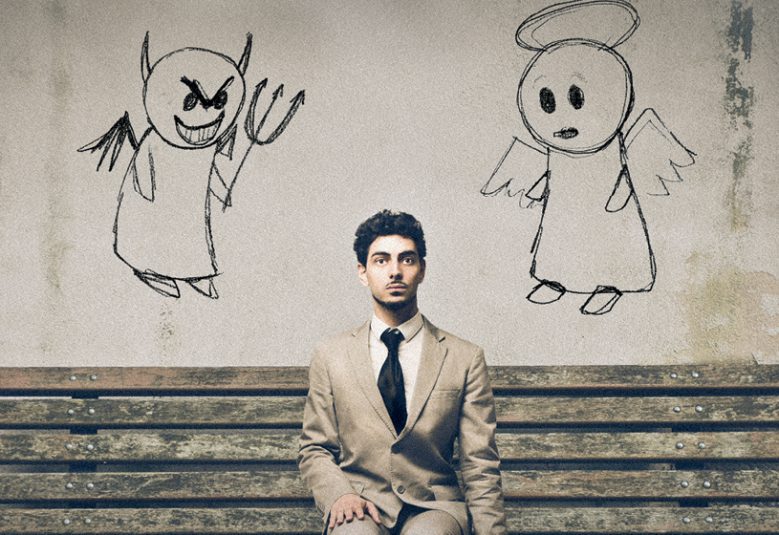 Man sitting on bench with an angel and a devil on his shoulders