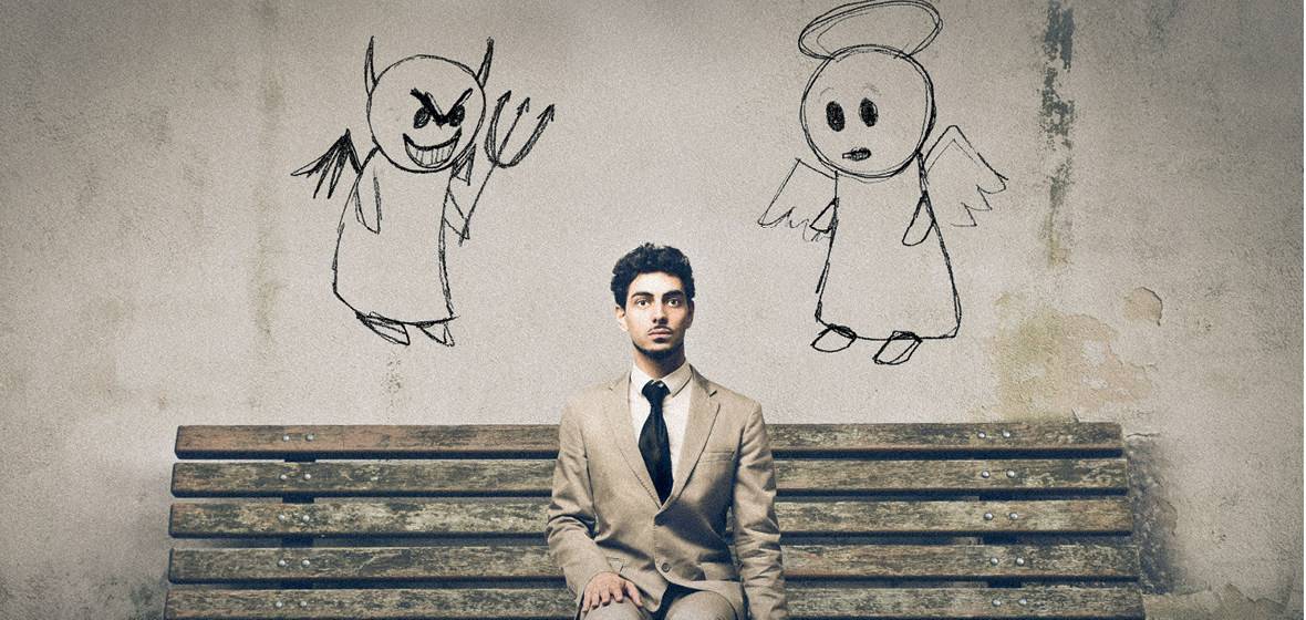 Man sitting on bench with an angel and a devil on his shoulders