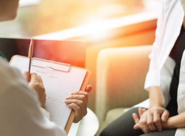 Patient sitting with physician for a consultation