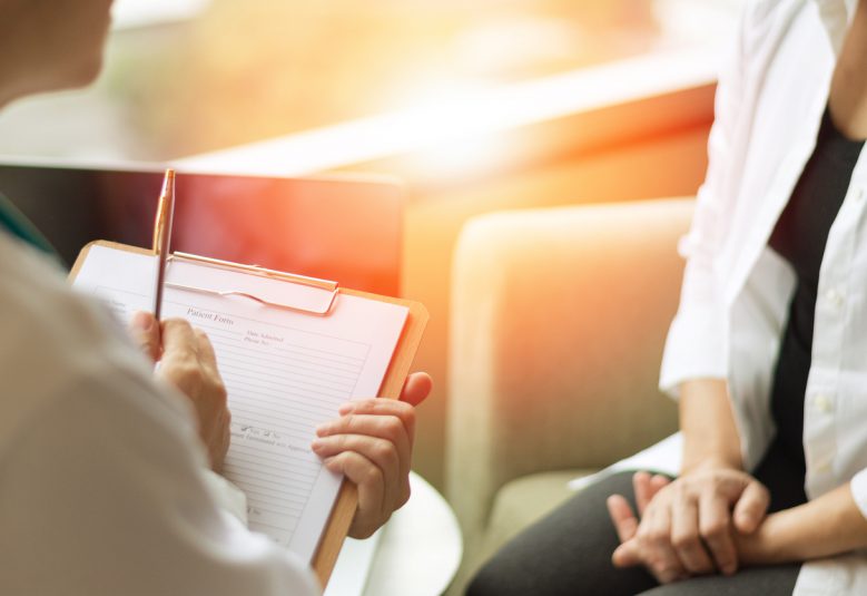 Patient sitting with physician for a consultation