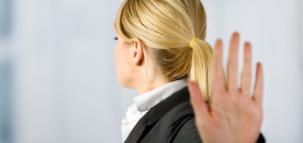 Businesswoman holding her palm out indicating Stop