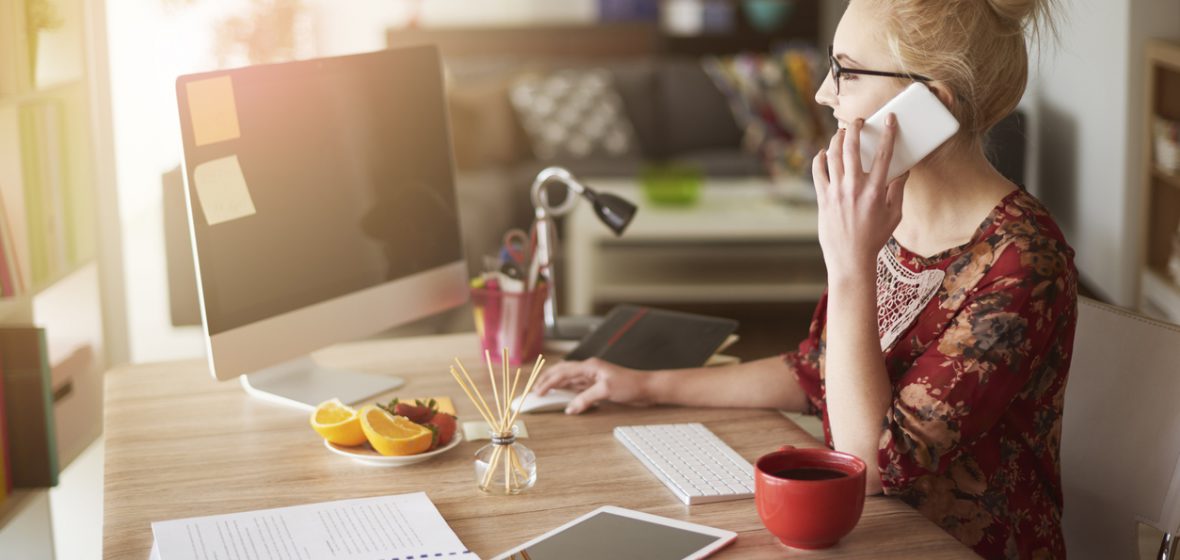 Woman works at a desk in a home office