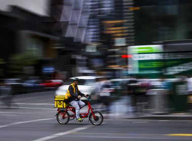 Person using bicycle for food delivery.