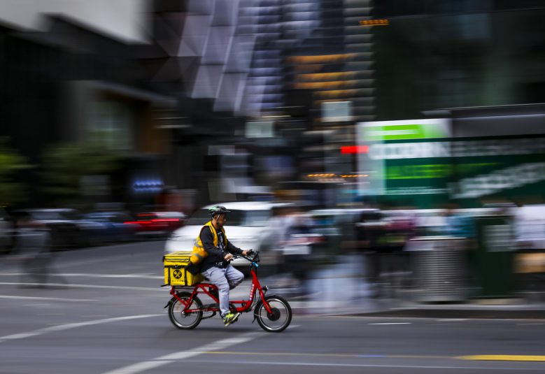 Person using bicycle for food delivery.