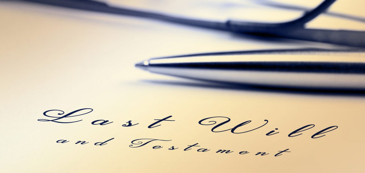 Last will and testament with pen and reading glasses.