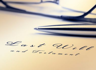 Last will and testament with pen and reading glasses.