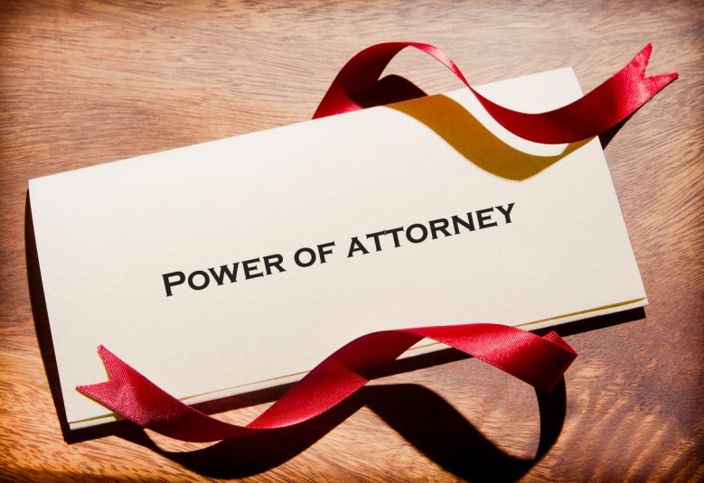 Power of Attorney document with red ribbon