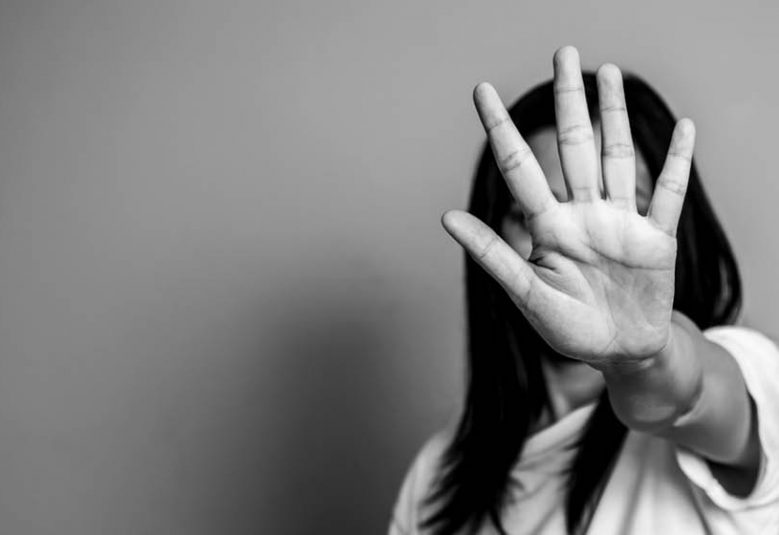 Woman holds her hand up to say stop