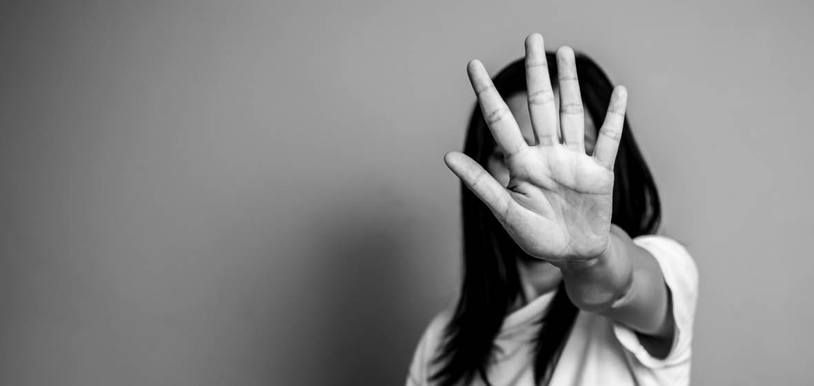 Woman holds her hand up to say stop