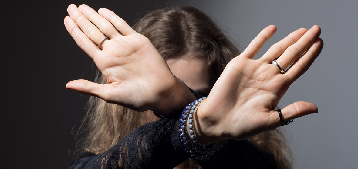 Woman holds her hand up to say stop