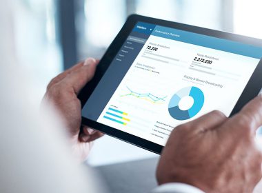 Man reviews figures on a tablet