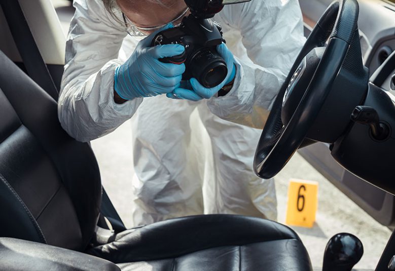 Police officer photographs interior of a car