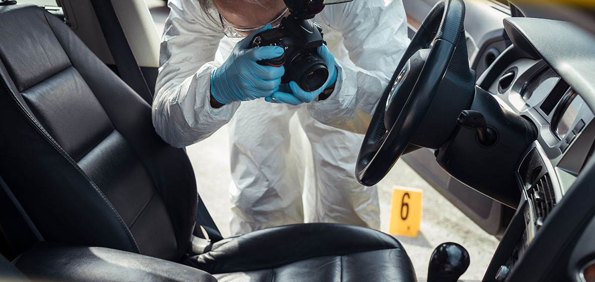 Police officer photographs interior of a car
